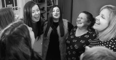 A picture of a group of women laughing and talking.