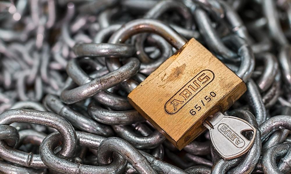 A pile of chains with a padlock on top iof it.