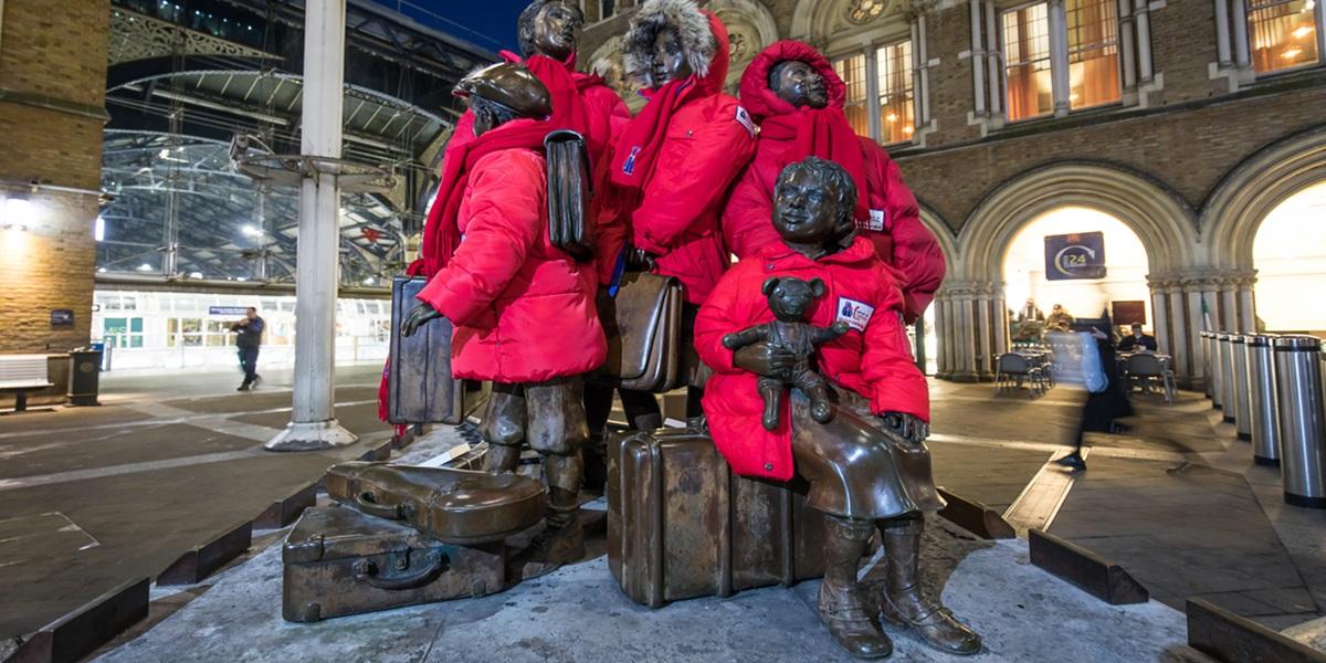 A statue in the city with red coats on to promote Wrap Up UK