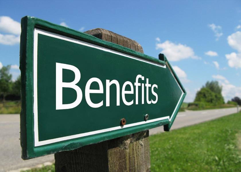 A sign saying benefits on a green pointing arrow