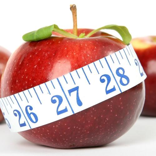 An apple with a tape measure around it