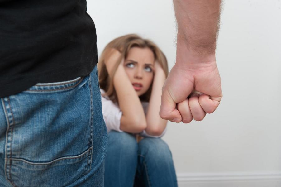 A man holding his fist with a women with her head in her hands