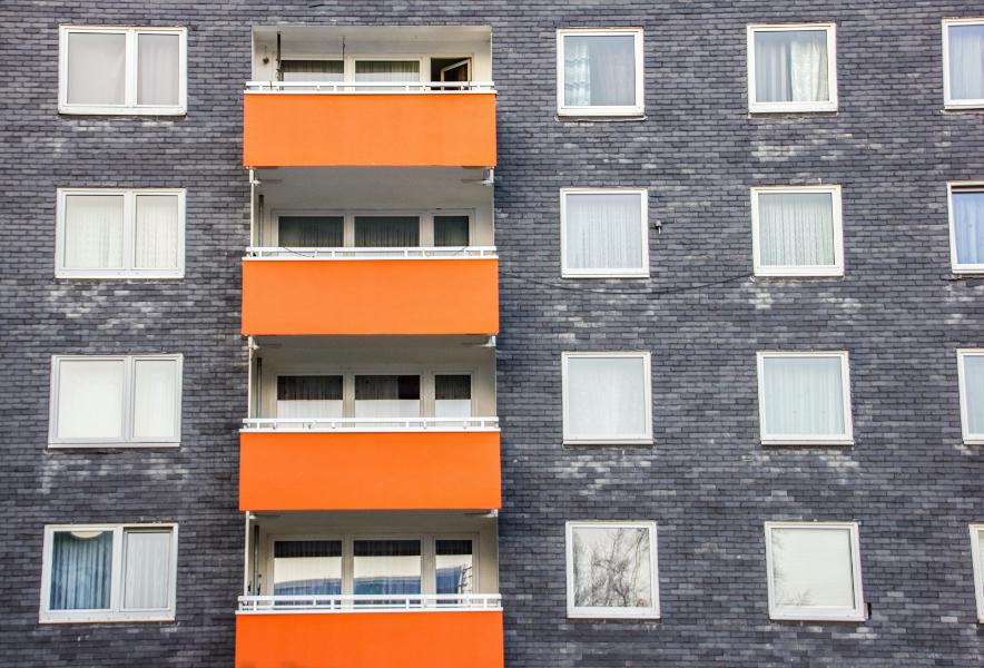 A block of flats with orange balconies 