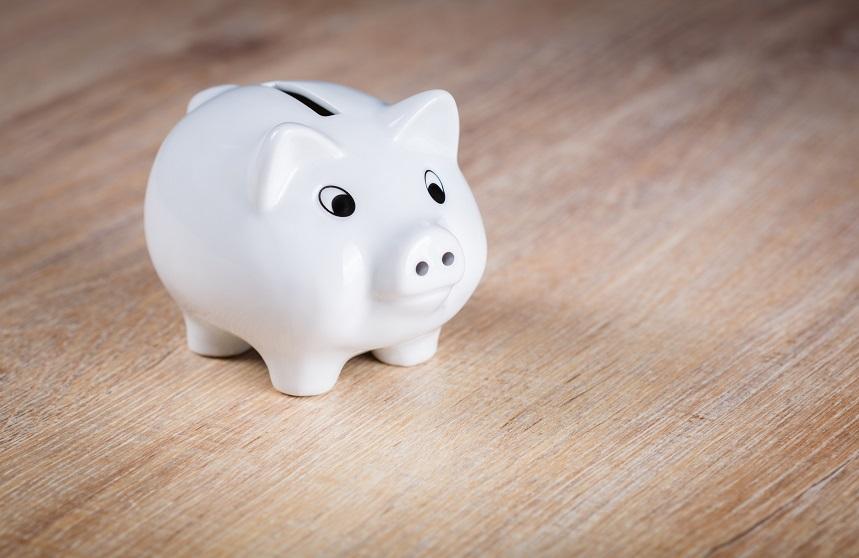 White piggy bank on a wooden surface