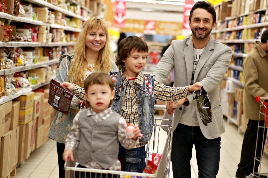 A Couple and two children shopping at the supermarket