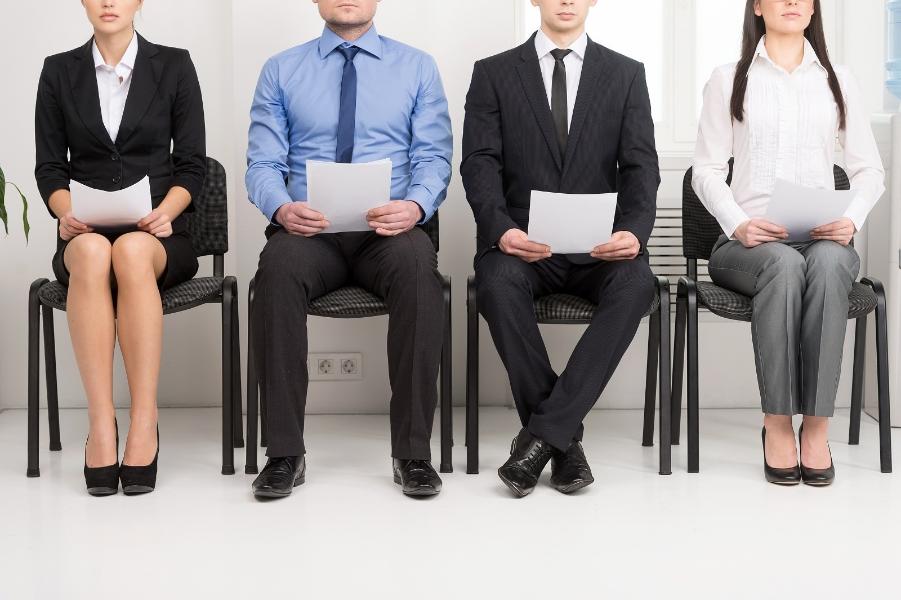 Four young people sat with their CVs ready for an interview 