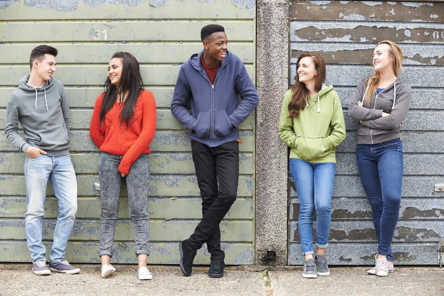 Four young adults stood chatting