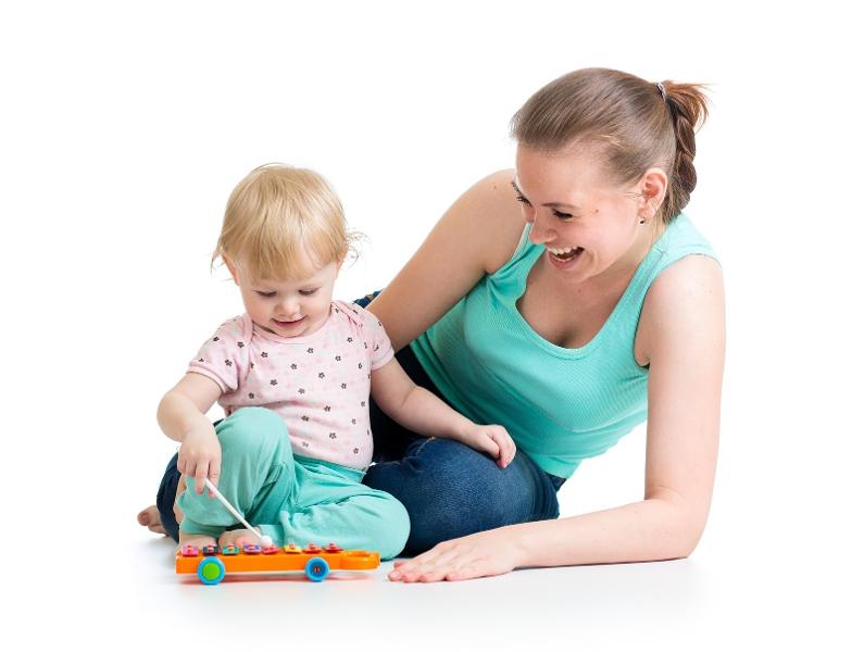 A mum playing with her daughter on a white background